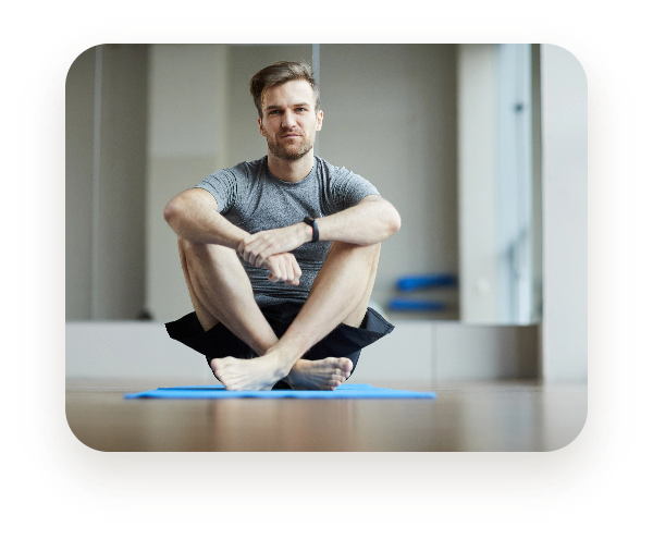 Man sitting on a mat for pilates classes