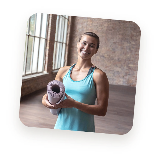 Smiling woman holding yoga mat